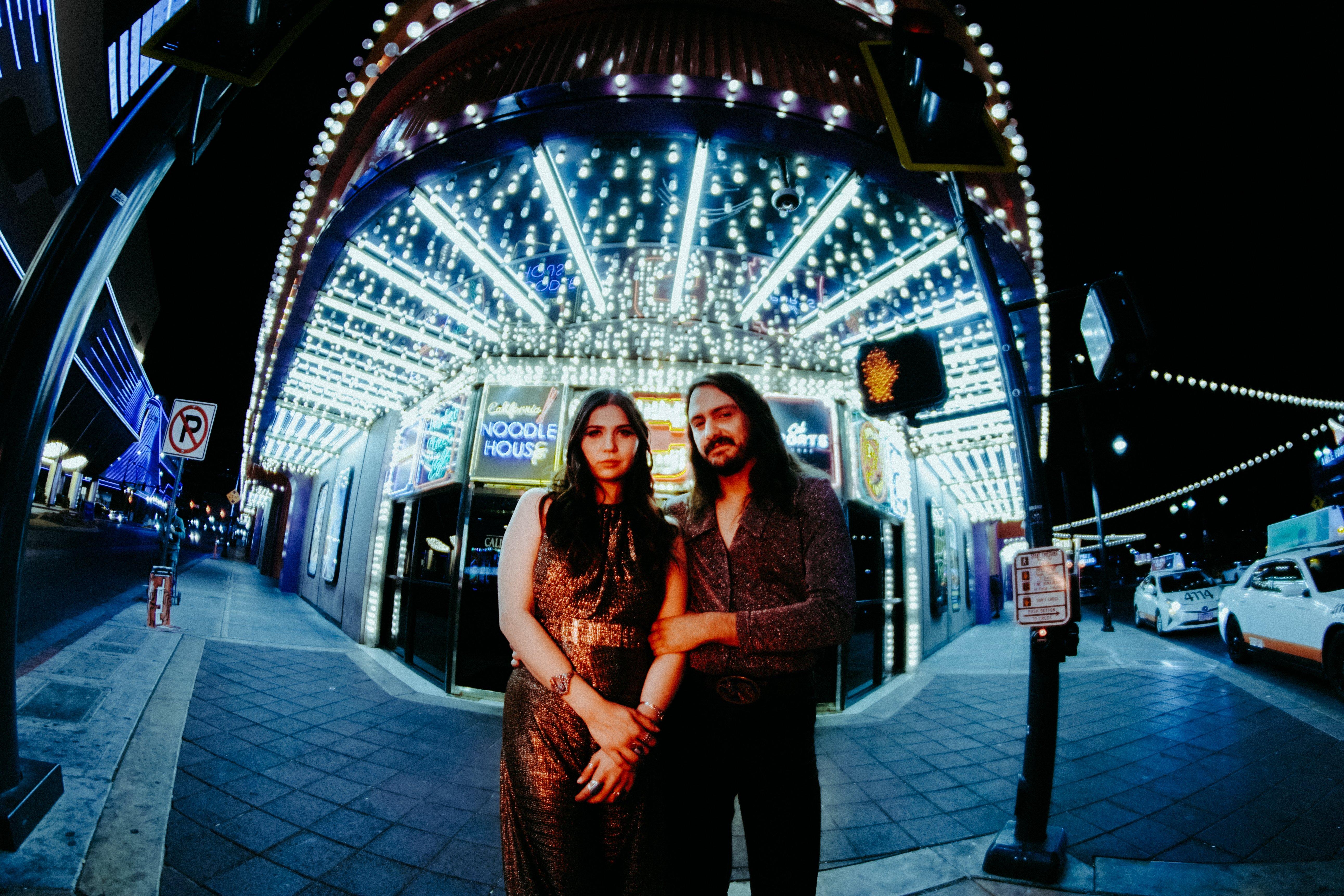 Photo Pearl Charles and Michael Rault in front of a venue
